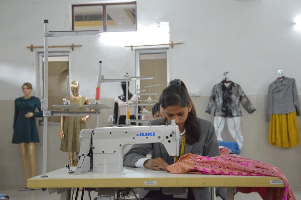 A Girl stitching a dress